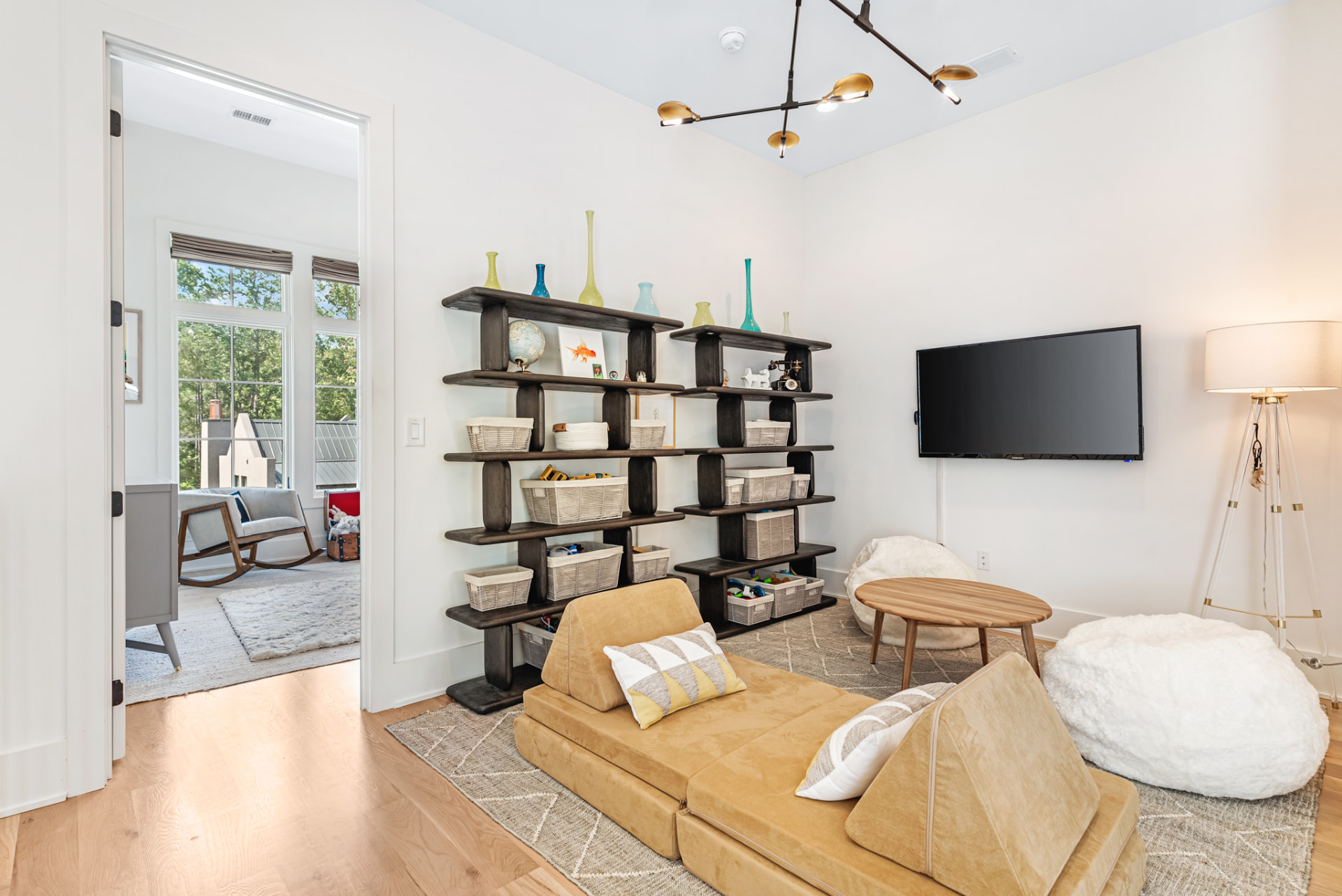 Playroom with dark oak shelving, floor cushions and bean bags