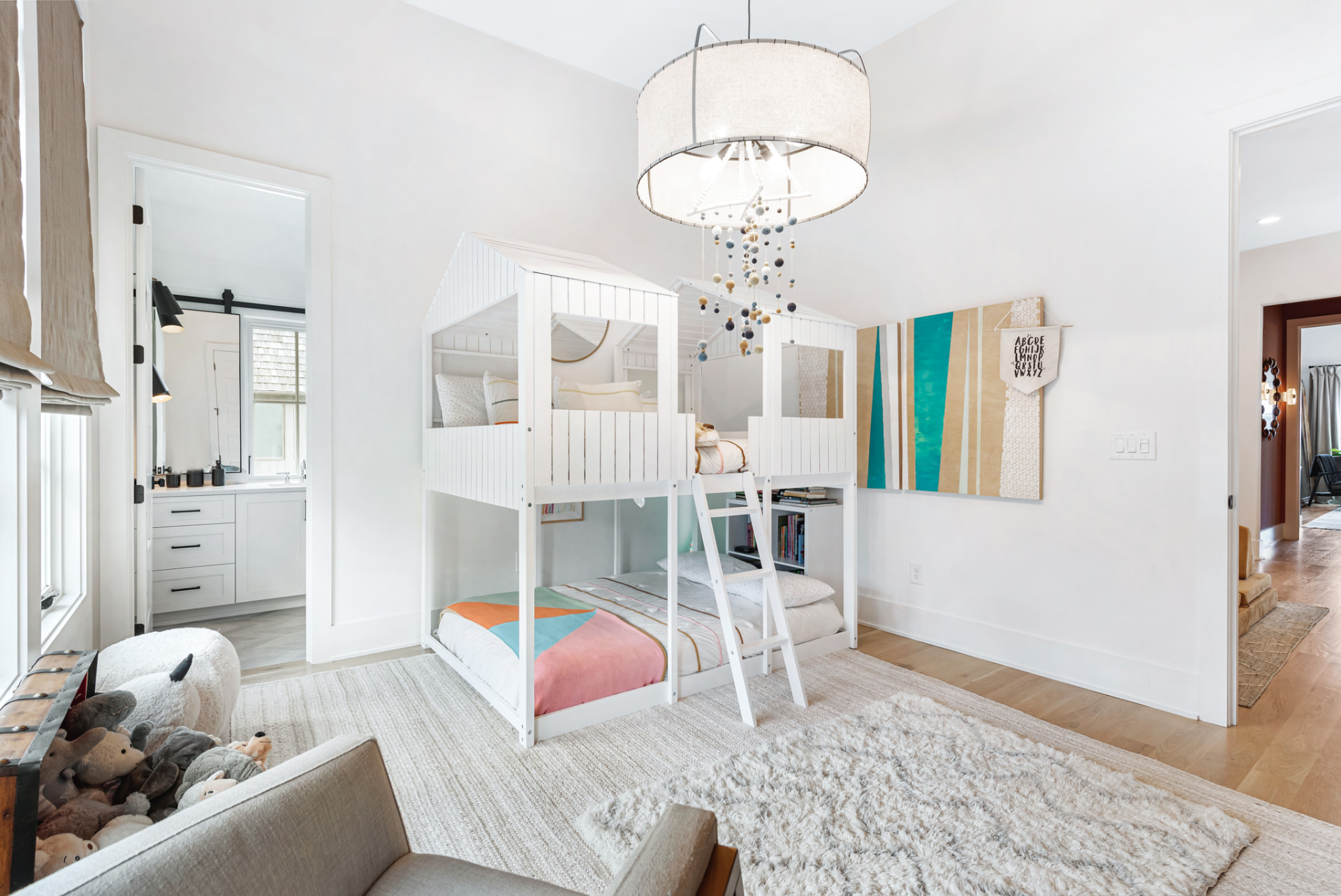 Children's room looking through to the ensuite with layered wool and shag rugs