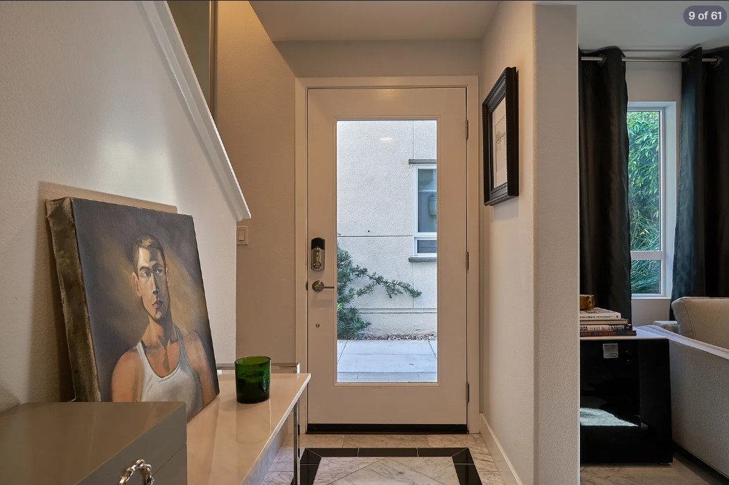 Entry hall with leaned portrait on a console and glazed garden door