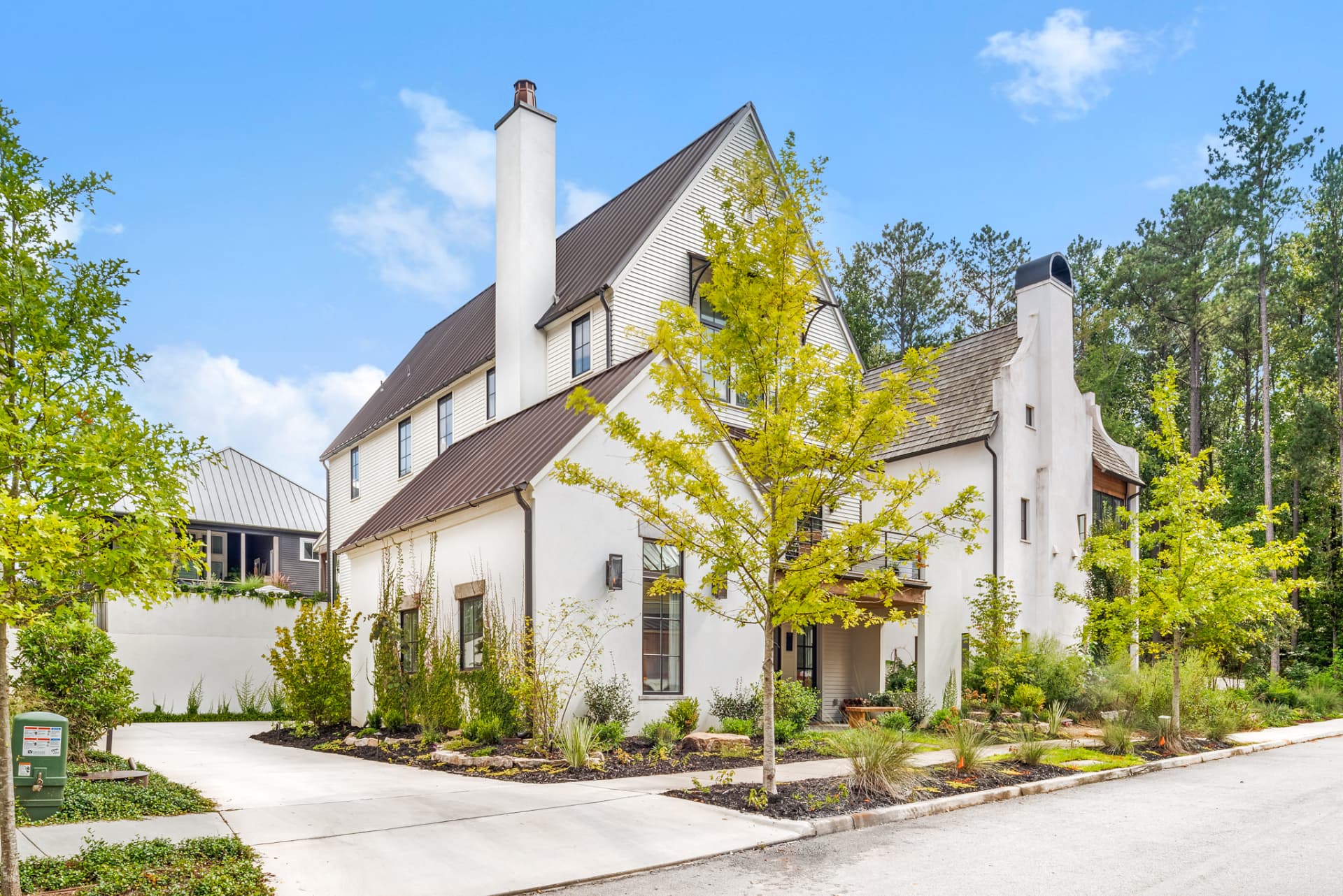 Side elevation showing gabled roofline, shutters and layered planting