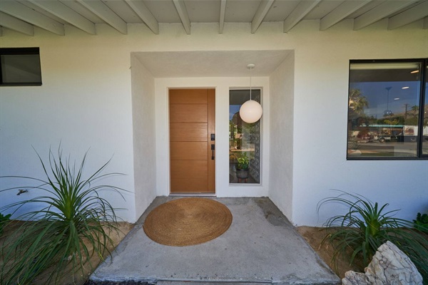 Entry with exposed beams, rift-oak door and opal globe pendant