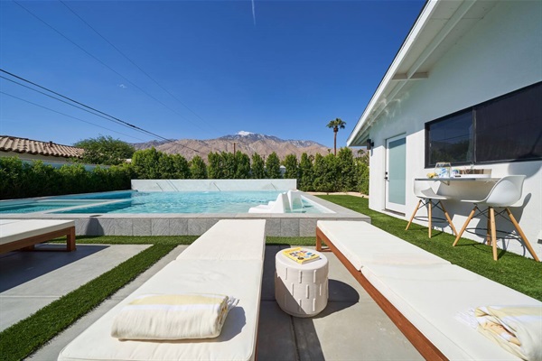 Chaises facing the pool with the San Jacinto mountains behind