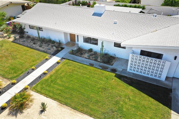 Aerial view of the low-slung ranch house, lawn and desert garden