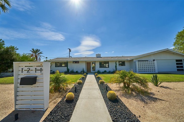 Street elevation with breeze-block screen, barrel cacti and desert planting