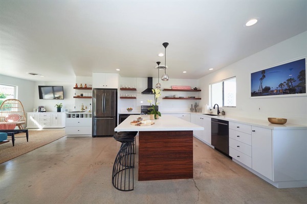 Kitchen with rosewood island, quartz counters and framed palm photograph